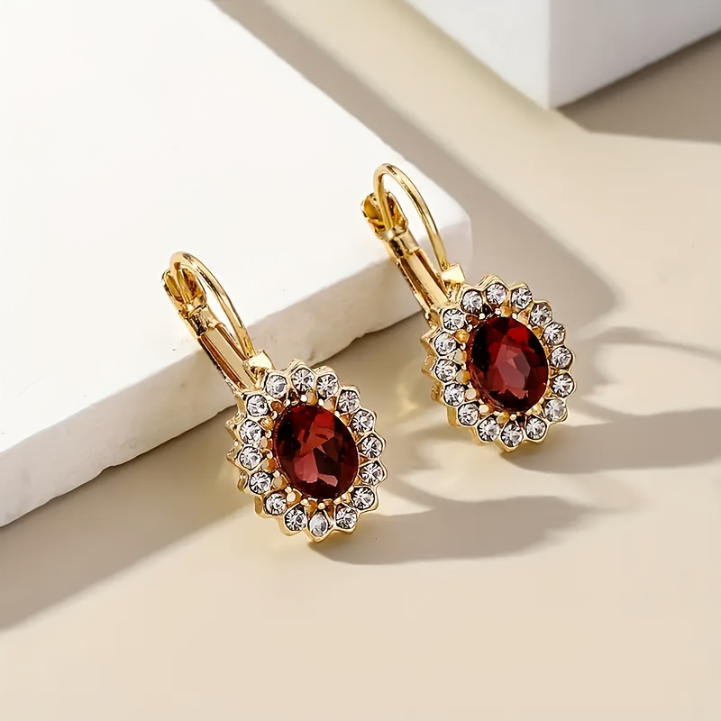 A Pair of Vintage Elegant Women'S Hoop Earrings Featuring Red And Clear Faux Gemstones in a Golden Tone, Perfect for Parties, Dinners, And As a Refined Gift for Women.