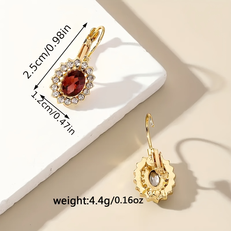 A Pair of Vintage Elegant Women'S Hoop Earrings Featuring Red And Clear Faux Gemstones in a Golden Tone, Perfect for Parties, Dinners, And As a Refined Gift for Women.